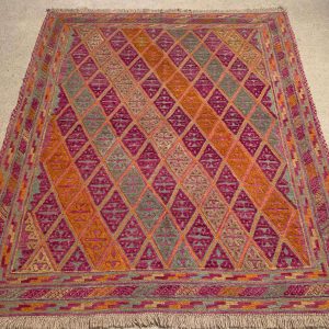 Close-up of Afghan Kilim Rug showing detailed pink and orange pattern.