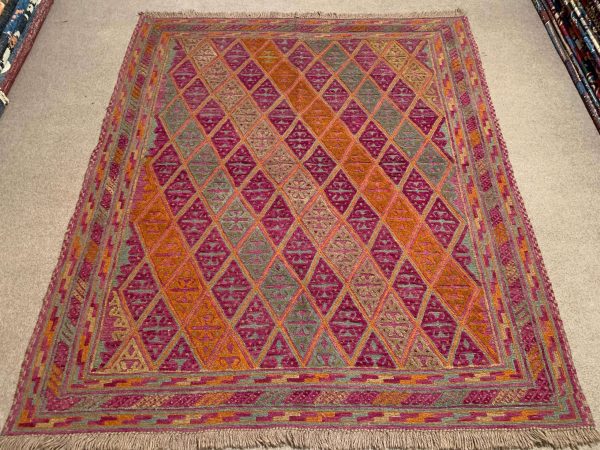 Close-up of Afghan Kilim Rug showing detailed pink and orange pattern.