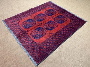 Green Afghan Kazak Hand-Knotted Wool Runner Rug close-up showing intricate design and soft pile